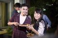 Asian young couple enjoying a romantic dinner and group of frie Royalty Free Stock Photo