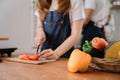 Asian young couple preparing a healthy meal together while spending free time at home Royalty Free Stock Photo