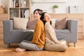 Asian young couple smile and laughing with positive emotion and loving together at warmth place. Attractive man and woman spending