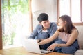 Asian young couple using laptop computer think and searching internet together Royalty Free Stock Photo