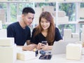 An Asian young couple is working while sitting in the office. Concept of business and e-commerce Royalty Free Stock Photo