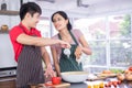 Asian Young Couples. Smiling, Cooking so fun. prepare salad for food together happily Royalty Free Stock Photo