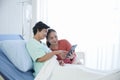 Asian young daughter caring of senior mother patient at hospital Royalty Free Stock Photo