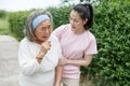 asian young daughter caring for sick senior mother To suffering illness or cough at home . old mom suffering from illness has an Royalty Free Stock Photo