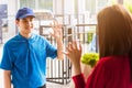 Delivery man making grocery service giving fresh vegetables in paper bag to woman customer Royalty Free Stock Photo