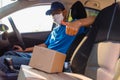 Delivery man courier online with boxes with uniform sitting in driving car Royalty Free Stock Photo