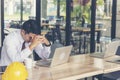 Asian young engineer man stress and failure in architecture project sitting at office on construction site. Upset despair civil Royalty Free Stock Photo