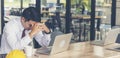 Asian young engineer man stress and failure in architecture project sitting at office on construction site. Upset despair civil Royalty Free Stock Photo