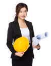 Asian Young engineer with yellow helmet and blue print Royalty Free Stock Photo