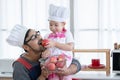 Asian young father with beard smiling and holding red apples basket in hands and little cute daughter giving dad an apple to eat Royalty Free Stock Photo