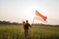 Asian young father with doughter flapping Indonesian flag Royalty Free Stock Photo