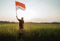 Asian young father with doughter flapping Indonesian flag Royalty Free Stock Photo