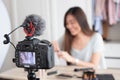 Asian young female blogger recording vlog video with makeup cosmetic at home online influencer on social media