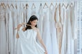 Asian young woman bride trying on wedding dress at modern wedding,Happy and smiling Royalty Free Stock Photo