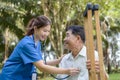 Asian Young Female Doctor Check Older Adult Health Condition and Provide Encouragement During Treatment. Rehabilitation or Royalty Free Stock Photo