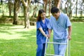 Asian Young Female Doctor Help Support Senior Patient and Provide Encouragement During Treatment. Rehabilitation or Physical Royalty Free Stock Photo