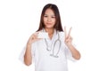 Asian young female doctor show victory sign with blank card