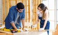 Asian young female engineer architect foreman labor worker wears safety goggles gloves and apron holdind using steel hammer Royalty Free Stock Photo