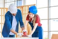 Asian young female engineer architect foreman labor worker wears safety goggles gloves and apron holdind using steel hammer Royalty Free Stock Photo