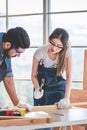 Asian young female engineer architect foreman labor worker wears safety goggles gloves and apron holdind using steel hammer Royalty Free Stock Photo