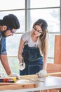Asian young female engineer architect foreman labor worker wears safety goggles gloves and apron holdind using steel hammer Royalty Free Stock Photo