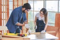 Asian young female engineer architect foreman labor worker wears safety goggles gloves and apron holdind using steel hammer Royalty Free Stock Photo