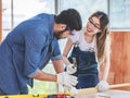 Asian young female engineer architect foreman labor worker wears safety goggles gloves and apron holdind using steel hammer Royalty Free Stock Photo