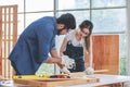 Asian young female engineer architect foreman labor worker wears safety goggles gloves and apron holdind using steel hammer Royalty Free Stock Photo