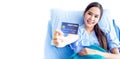Asian young female patients show a demo credit card in hand. To pay medical expenses With smiles and bright facial expressions in