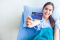 Asian young female patients show a demo credit card in hand. To pay medical expenses With smiles and bright facial expressions in