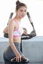 asian young fitness woman in sportswear exercising with biking in sport gym club . girl workout on bike machine Royalty Free Stock Photo