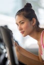 asian young fitness woman in sportswear exercising with biking in sport gym club . girl workout on bike machine Royalty Free Stock Photo