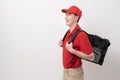 Asian Young food delivery man wearing red uniform carrying food baggage smiling on white background Royalty Free Stock Photo