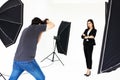 Asian young friendly pretty long straight hair female model smiles and cross arms posing and photographer shooting in studio Royalty Free Stock Photo