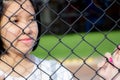 Asian young girl behind chain link fence Royalty Free Stock Photo