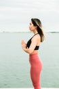 Asian young girl doing yoga outdoors on the pier by the lake Royalty Free Stock Photo