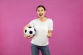 Asian Young Girl Football fan over isolated pink background holding a soccer ball, sport and people Royalty Free Stock Photo