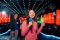 Asian young girl with friends dancing and singing at karaoke bar Royalty Free Stock Photo