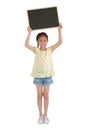 Asian young girl holding blank blackboard over head isolated on white background. Full length Royalty Free Stock Photo