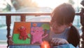Asian young girl sits happily making plasticine in the house during the sunset. Ideas for creativity and the use of free time to Royalty Free Stock Photo