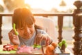 Asian young girl sits happily making plasticine in the house during the sunset. Ideas for creativity and the use of free time to Royalty Free Stock Photo