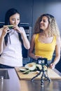 Asian young girl tasting a piece of melon