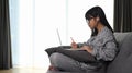 Asian young girl using laptop computer studying homework during her online lesson. Royalty Free Stock Photo