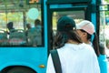 Asian young girl wear hat waiting for bus at bus stop