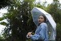 Asian young girl wear jean coat with umbrella in the garden