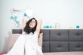 Asian young glasses woman stretches oneself on her bed in the morning Royalty Free Stock Photo