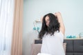 Asian young glasses woman stretches oneself on her bed in the morning Royalty Free Stock Photo