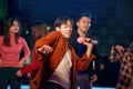 Asian young guy with friends dancing and singing at karaoke bar Royalty Free Stock Photo