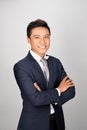 Asian young handsome businessman standing arms crossed, smiling happy, looking at camera Royalty Free Stock Photo