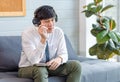 Asian young handsome professional successful male businessman employee in formal business shirt and necktie sitting on cozy sofa Royalty Free Stock Photo